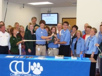Christian Paese joins Blackhawk’s board of directors and the Forward Janesville team at the 2009 ribbon cutting ceremony for Cougar Credit Union.