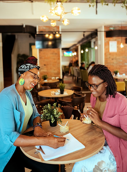 Two businesswomen working at coffee shop