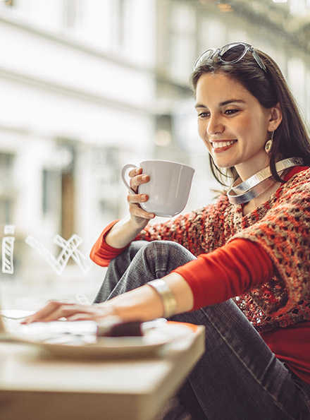 Woman using laptop in coffee shop