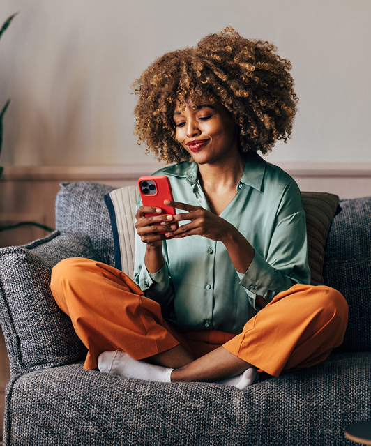 Woman using phone in living room