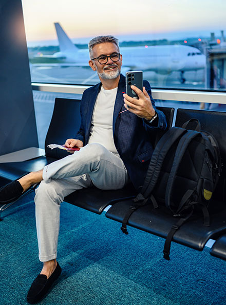 Man using phone at airport
