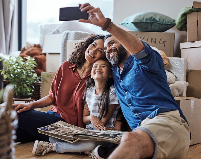 Young family taking a selfie in living room