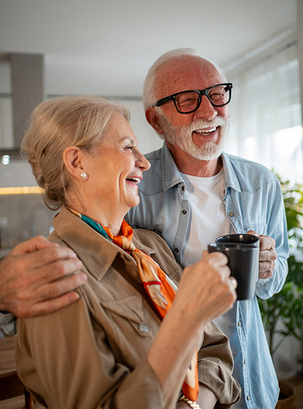 Mature couple having coffee in kitchen