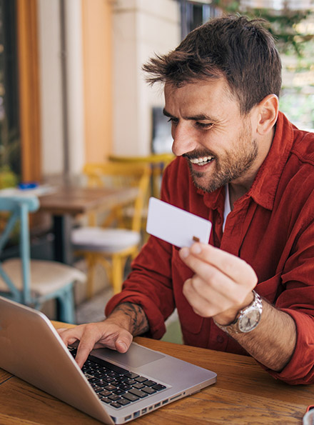 Man using debit card to shop online