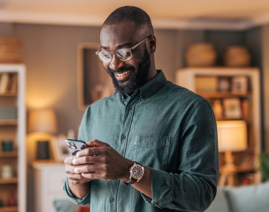 Man using phone in living room