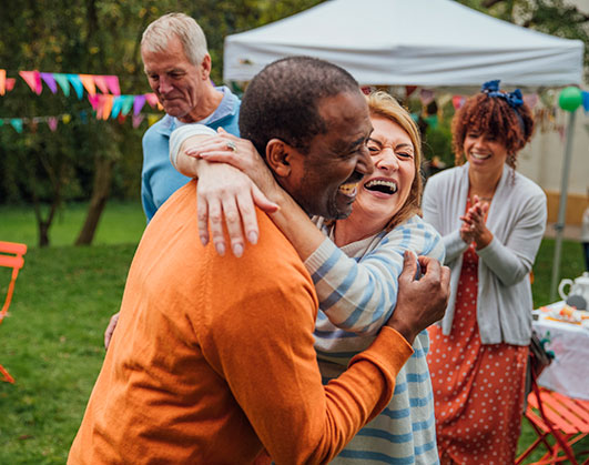 Two people hugging at community event