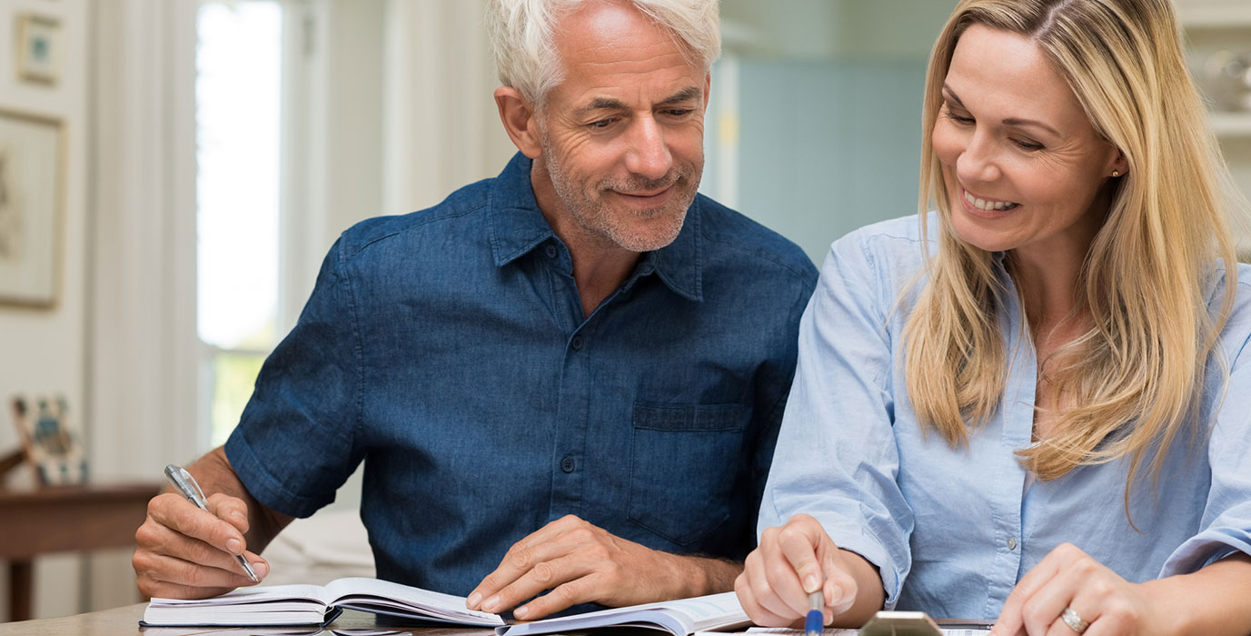 Mature couple going over finances in living room