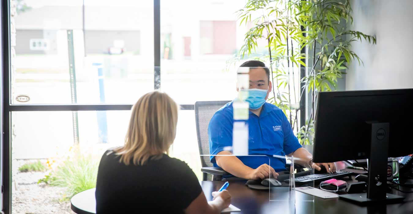 Tim, a Mortgage Loan Officer assisting a member in his office.