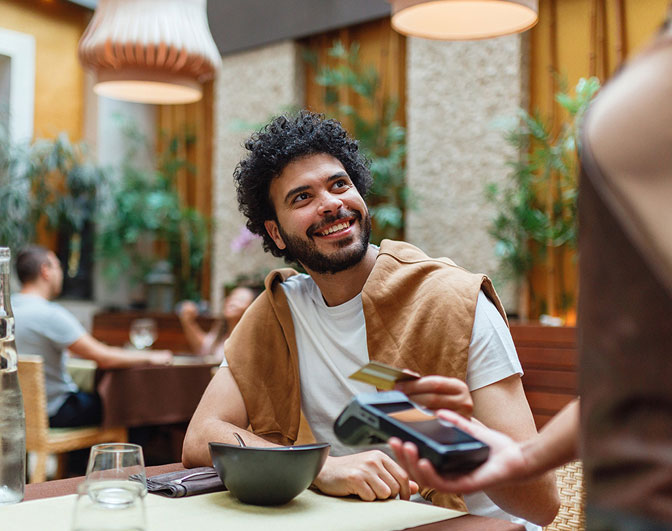Man paying with credit card in restaurant