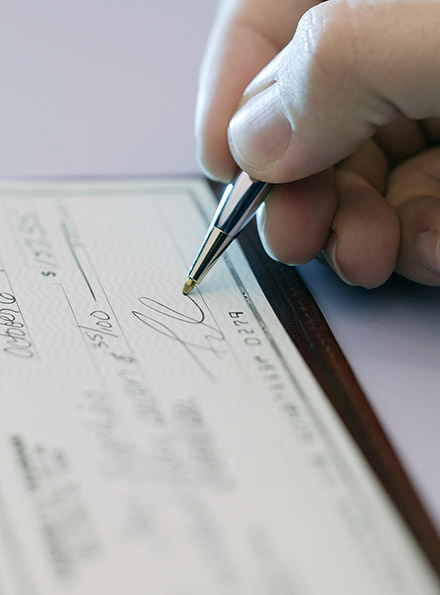 Person writing a check